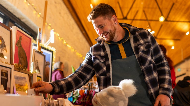 Man and daughter browse christmas market at Castle Ward